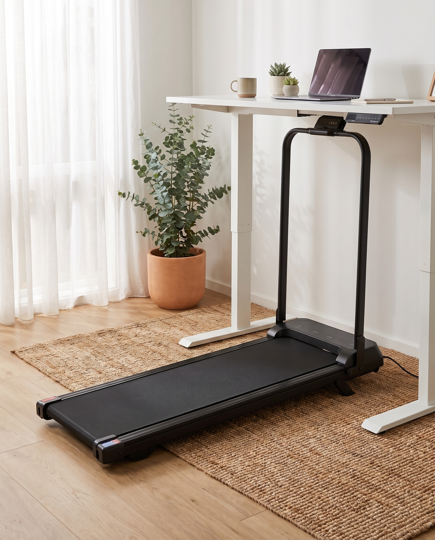The Aus Walking Pad under a standing desk, handle bar up, side profile